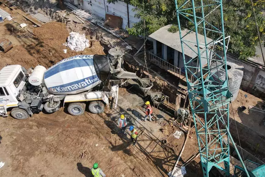 A top view image of an RMC mixing machine pouring concrete into an excavated cavity for diaphragm walls