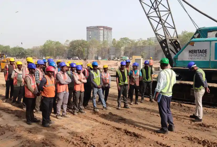 Construction workers at a deep basement project site getting instructions