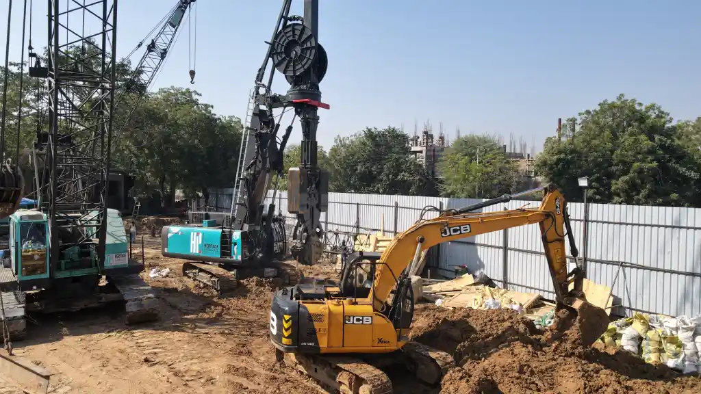 An excavation rig and earth mover cranes at a construction site